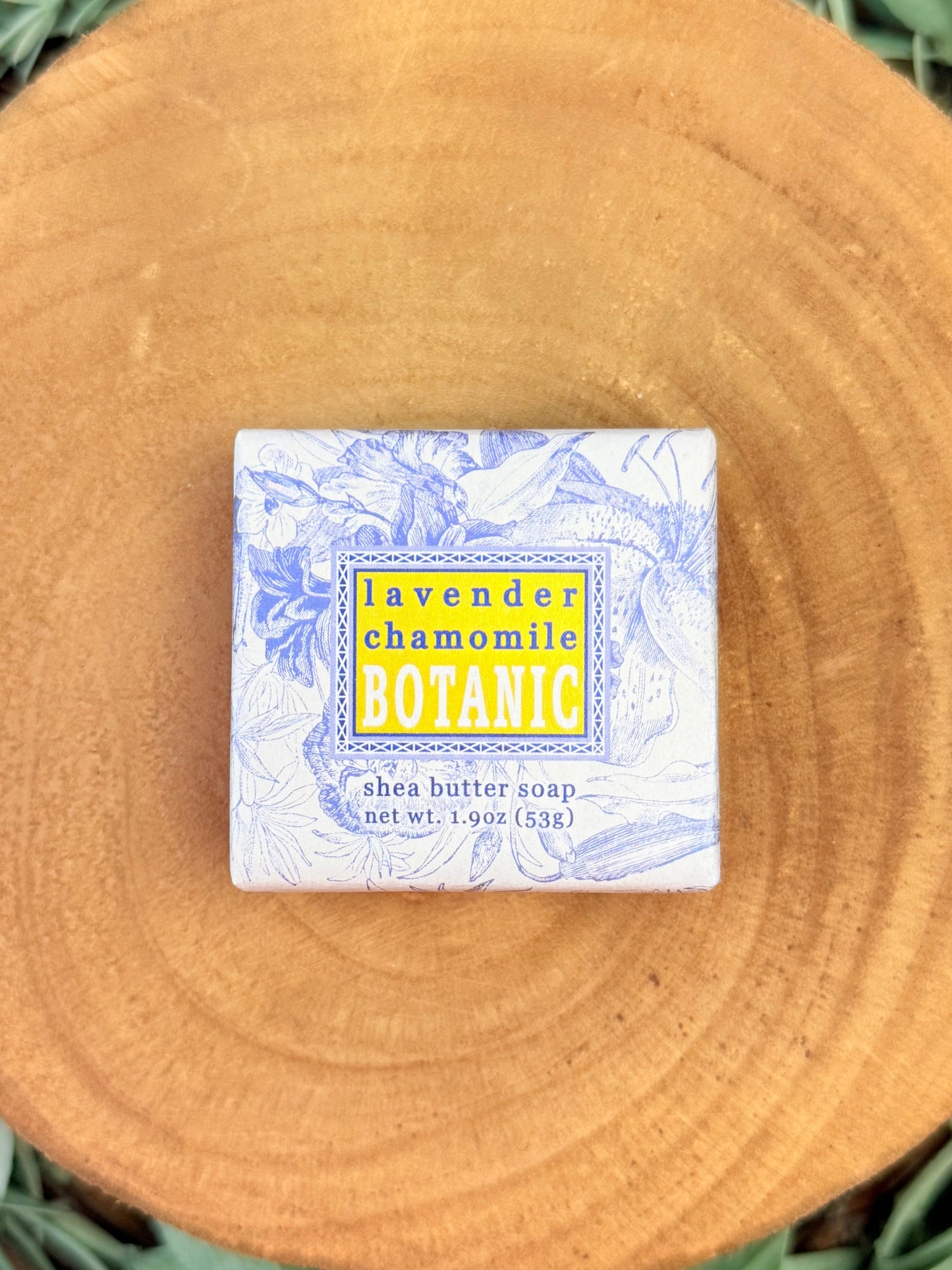 Shea butter soap bar with a decorative label on a wooden surface