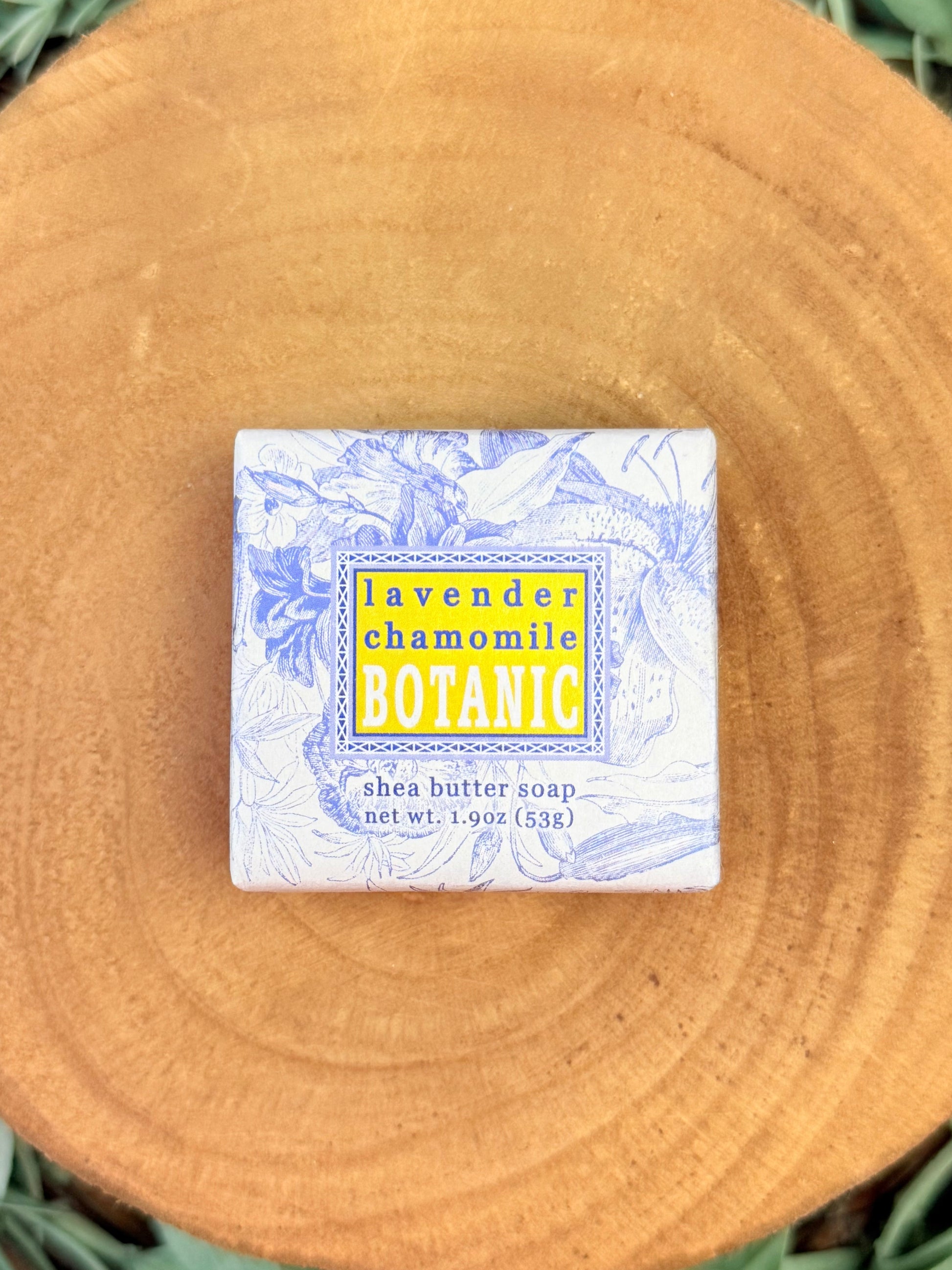 Shea butter soap bar with a decorative label on a wooden surface