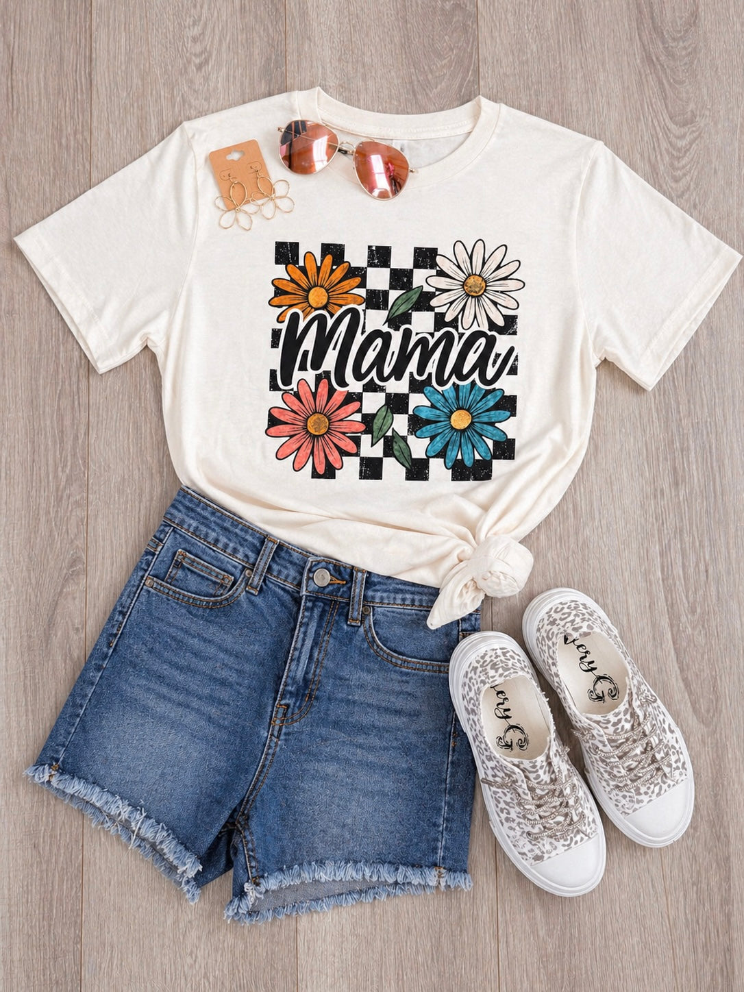 Mama floral checkered graphic tee on cream Tultex shirt styled with denim shorts and sneakers flat lay