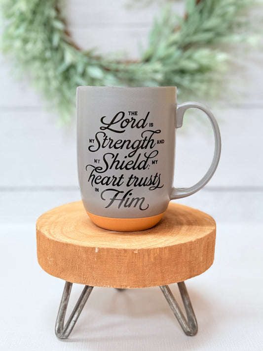 Christian coffee mug with Psalm 28:7 scripture “The Lord is my strength and my shield” in neutral design