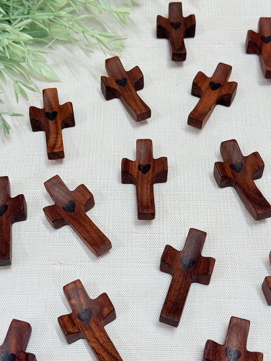 wooden pocket prayer crosses on a flat surface
