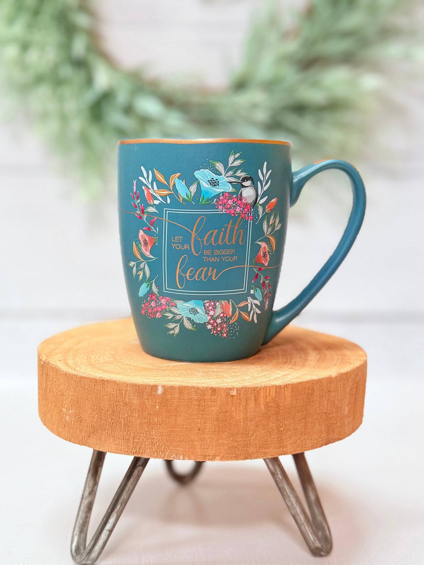 Blue mug with floral design and text on a wooden stool. let your faith be bigger than your fear christian coffee mug
